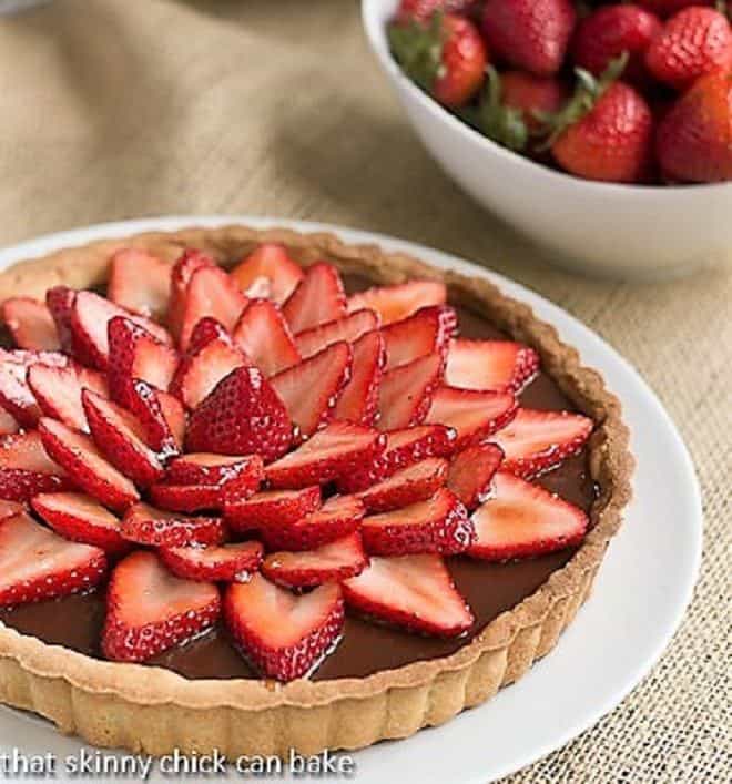 Strawberry Topped Chocolate Tart on a white serving plate