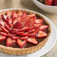 Strawberry Topped Chocolate Tart on a white ceramic plate