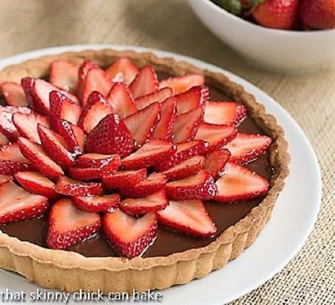 Strawberry Topped Chocolate Tart on a white ceramic plate