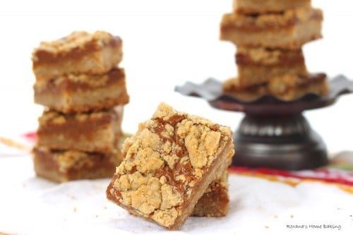 dulce de leche bars stacked and on a small pedestal