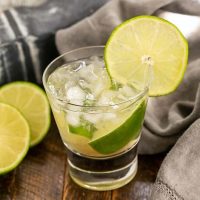 Caipirinha Cocktail in a highball glass with a lime garnish