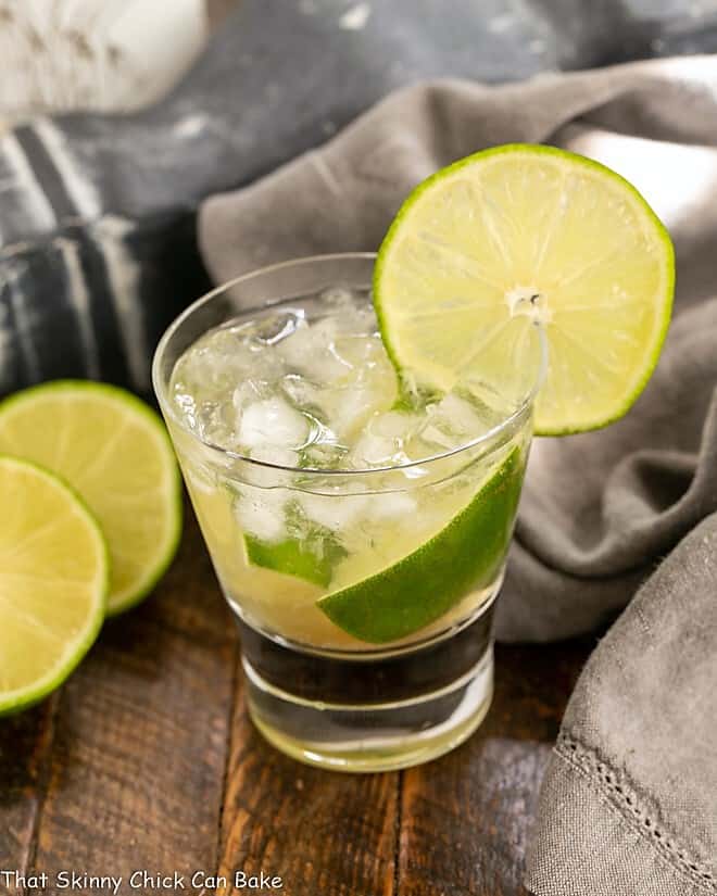 Caipirinha Cocktail in a highball glass with a lime garnish.