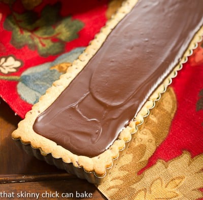 Chocolate Chip Cookie Tart with Caramel and Chocolate Glaze in a rectangular tart pan