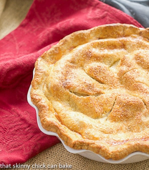 Classic Apple Pie in a ruffled white pie plate.
