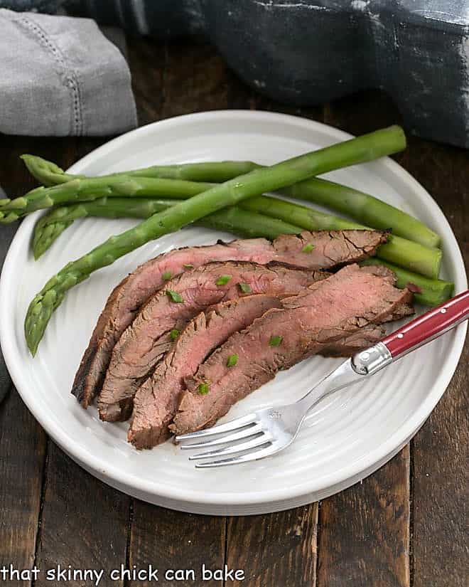 Korean Beef grilled and sliced on a white dinner plate.