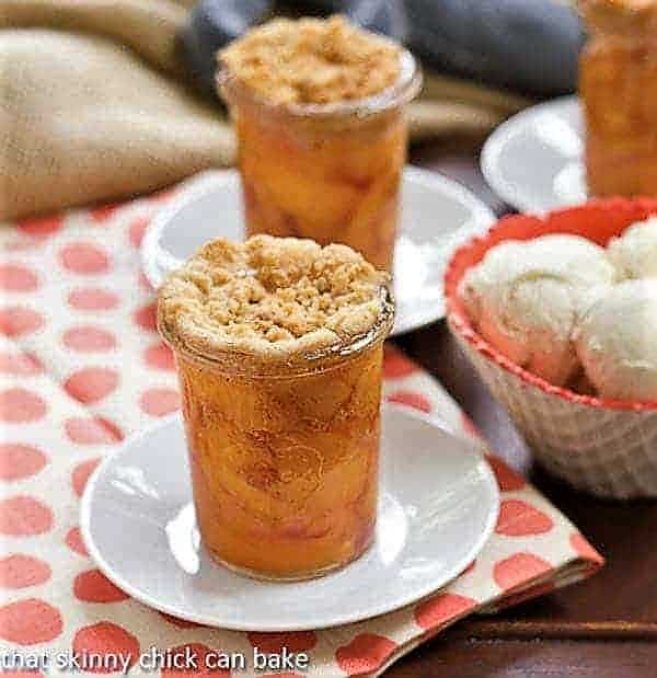 Peach Crisp in Jars next to a bowl of ice cream