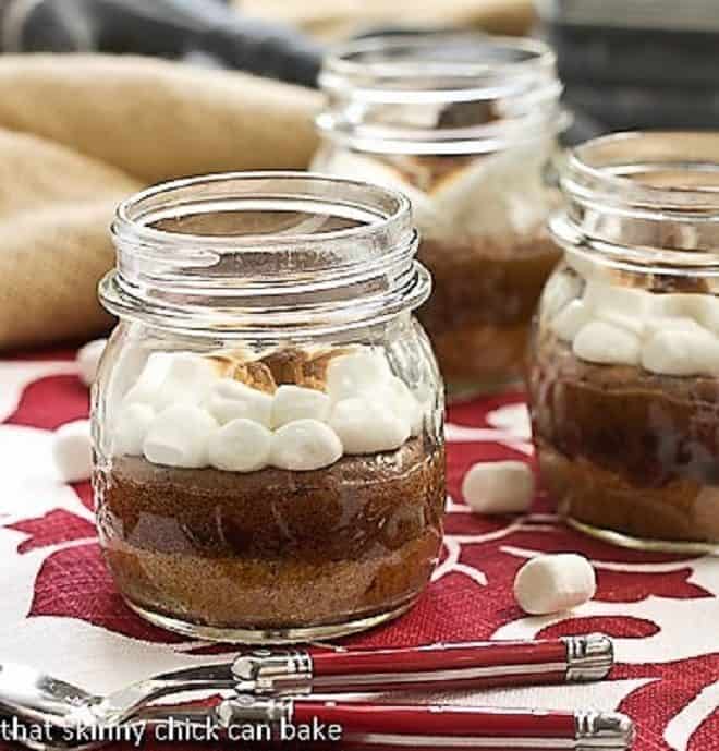 S'mores Brownies in Jars on a red and white napkin with two spoons