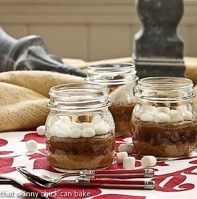 Threee S'mores Brownies in Jars with red handled spoons