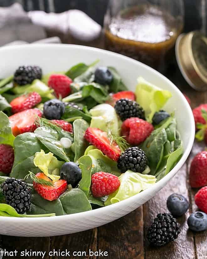 Spinach Almond and Berries Salad in a white serving bowl