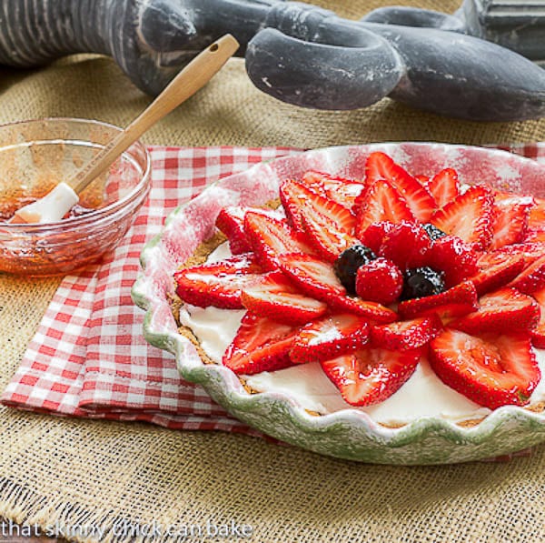 Strawberry Cream Cheese Dessert with a bowl and brush with glaze topping