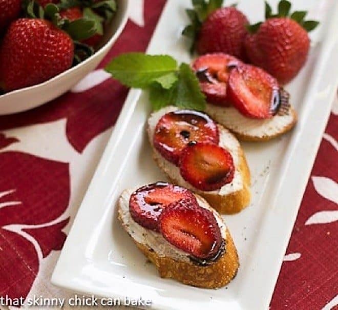 Strawberry Toasts topped with goat cheese, sliced berries and a drizzle of balsamic vinegar