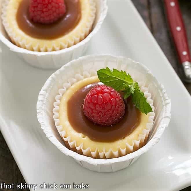 Close overhead view of mini cheesecakes topped with caramel and mint