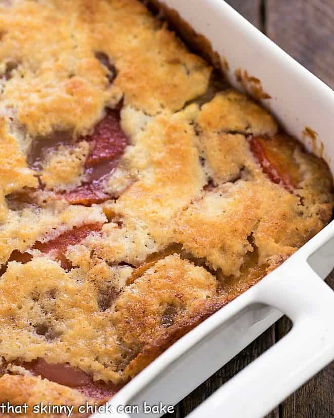 Close view of an easy peach cobbler in a white baking dish.