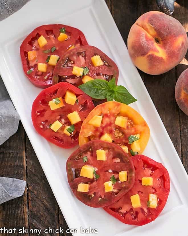 Tomatoes overlapping on a white ceramic platter