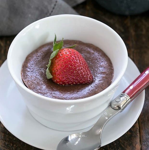 A warm chocolate cheesecake topped with a strawberry