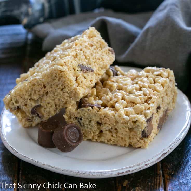 2 rolo rice krispie treats one leaning on another on a round white plate.