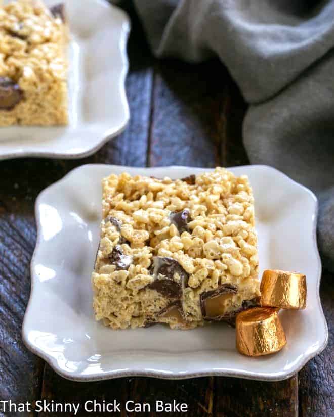 Caramel Rolo Rice Krispie Treat on a square white plate with 2 Rolos.