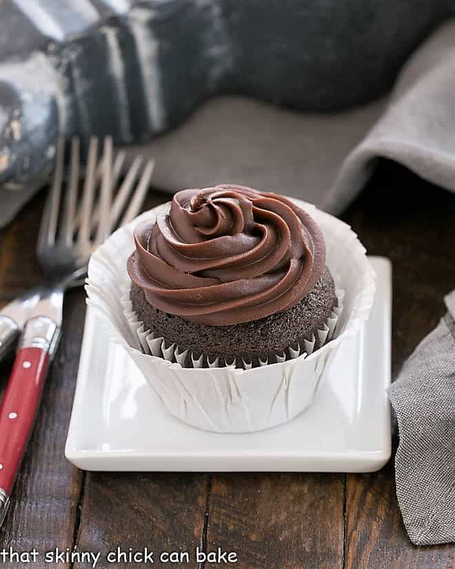 One chocolate blender cupcakes on a square white plate.