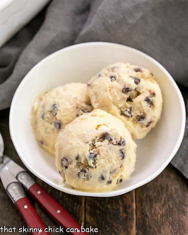 Overhead view of 3 scoops of cookie dough ice cream in a white bowl