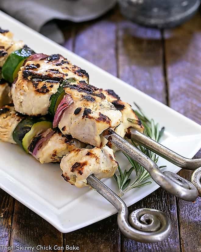 Grilled Feta Chicken Kabobs on a white serving tray