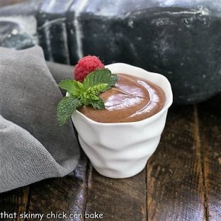 French Chocolate Mousse in a white ceramic cup topped with mint and a fresh raspberry
