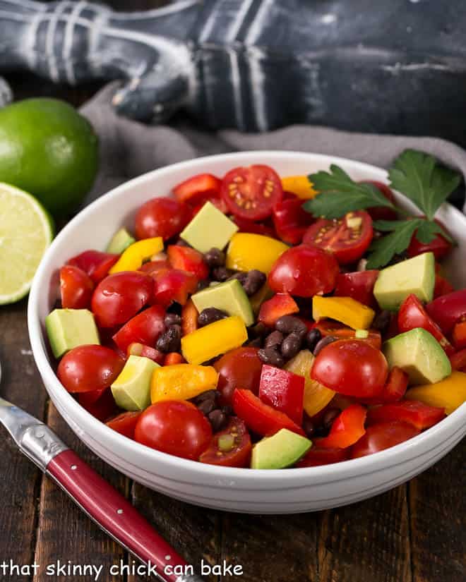 Guacamole Salad or Avocado Salad in a white serving bowl with a red handle fork.