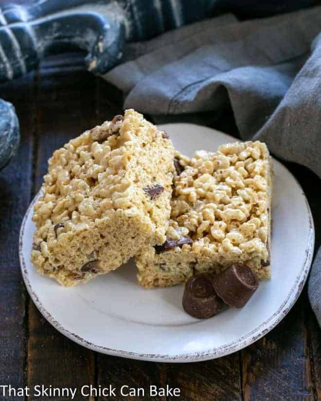 2 Caramel Rolo Rice Krispie Treats on a round white plate.