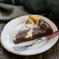 A slice of Marbled Flourless Chocolate Cake on a white dessert plate