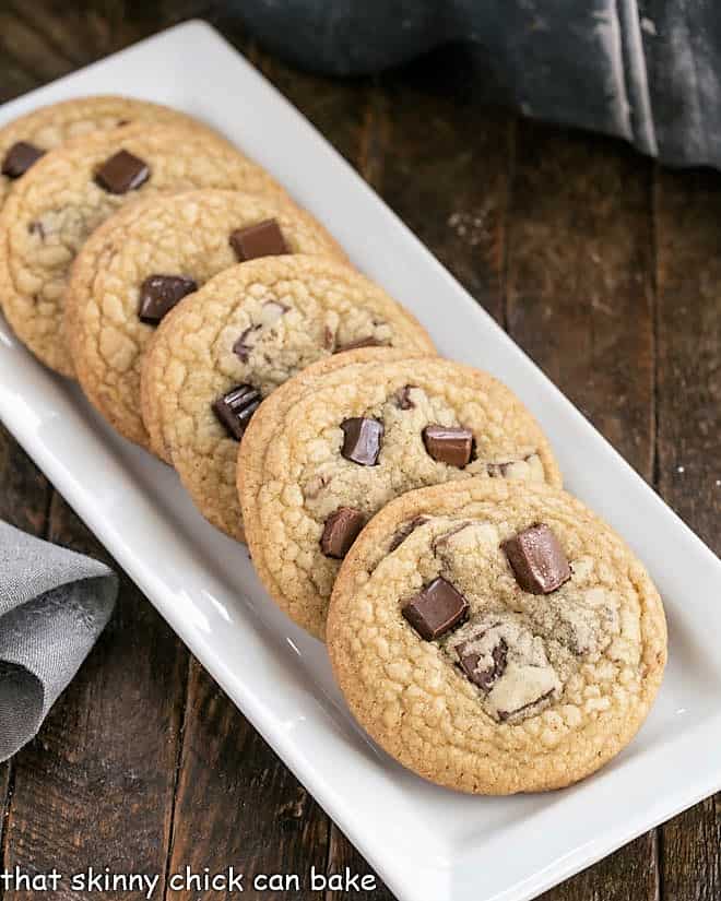 Brown Sugar Chocolate Chunk Cookies lined up on a narrow white tray.