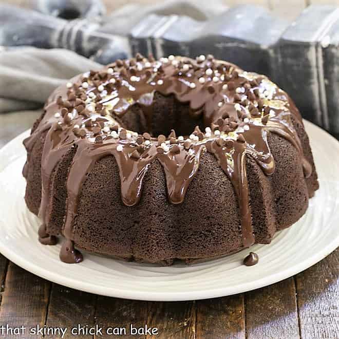 Chocolate Sour Cream Bundt Cake on a white cake plate.