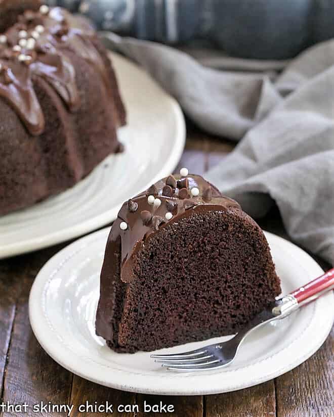 Slice of Sour Cream Bundt Cake on a white plate with a red handled fork.