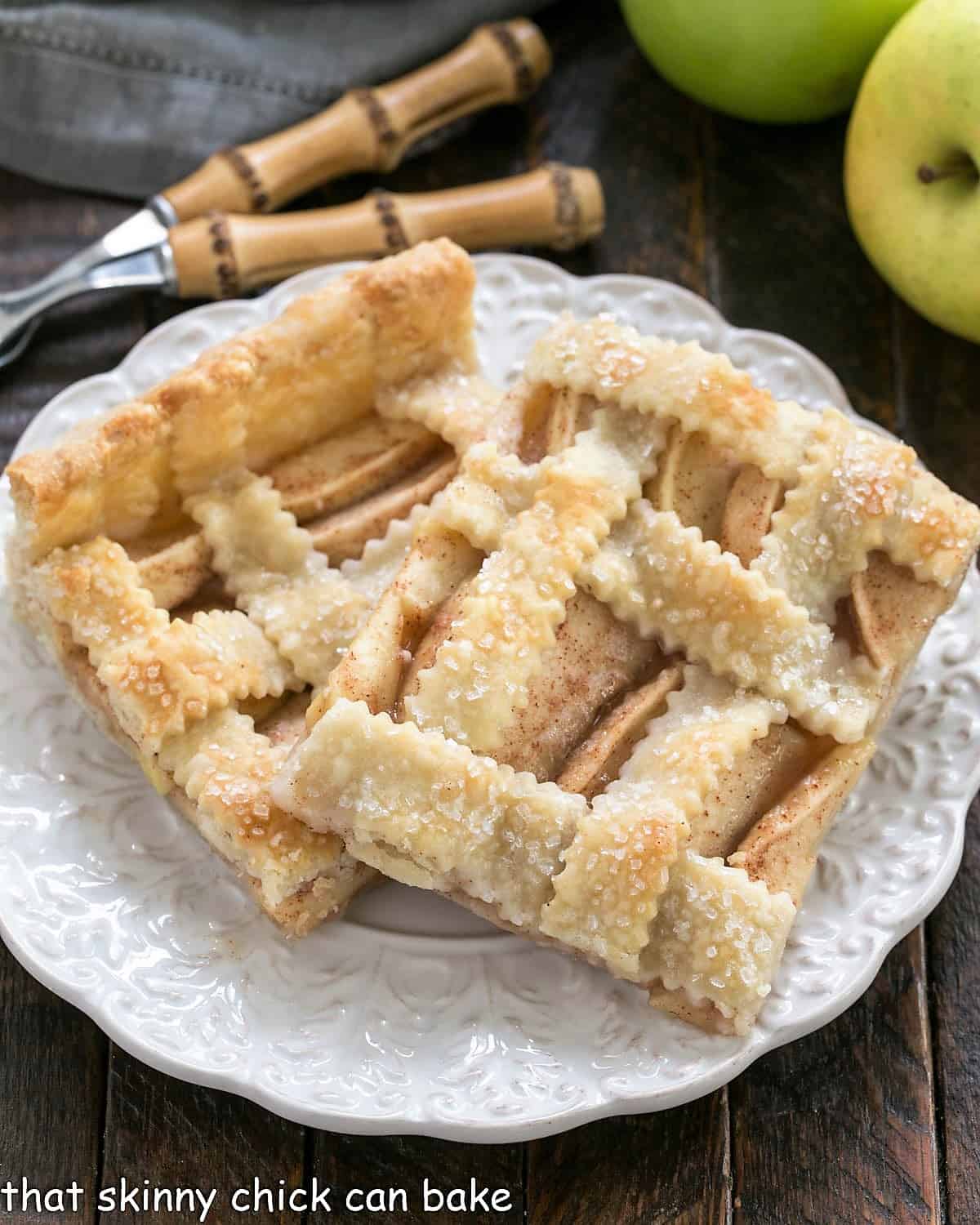 2 slices of Cinnamon Apple Squares on a round white plate.