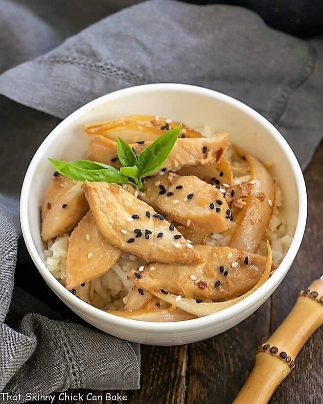 Easy chicken bulgoge in a white bowl garnished with a sprig of basil