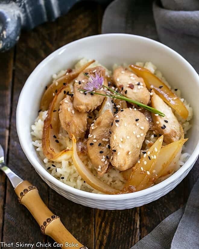 Overhead view of Chicken Bulgogi in a white bowl garnished with chives