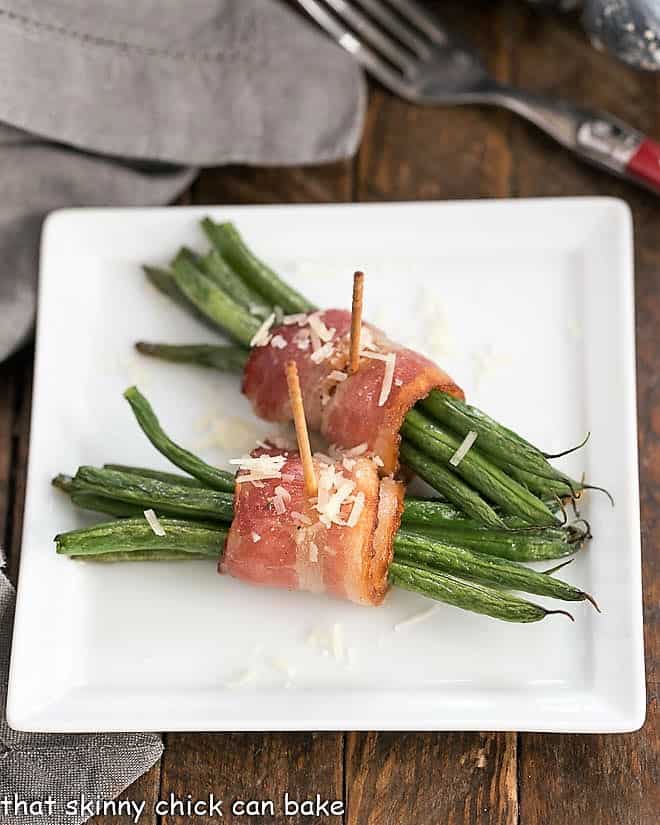 Green Bean and Bacon Bundles on a square plate.