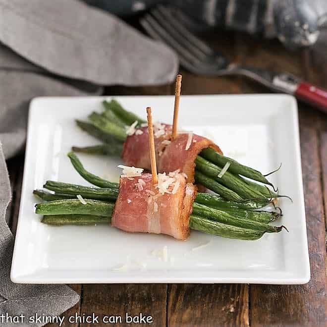 Two Green Bean and Bacon Bundles on a square white plate