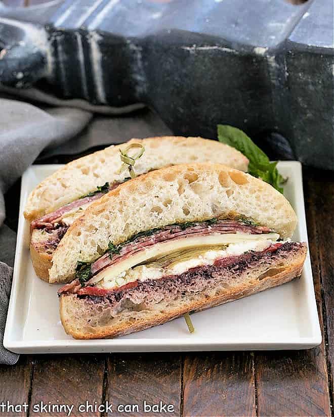 Slices of picnic sandwich on a white plate.