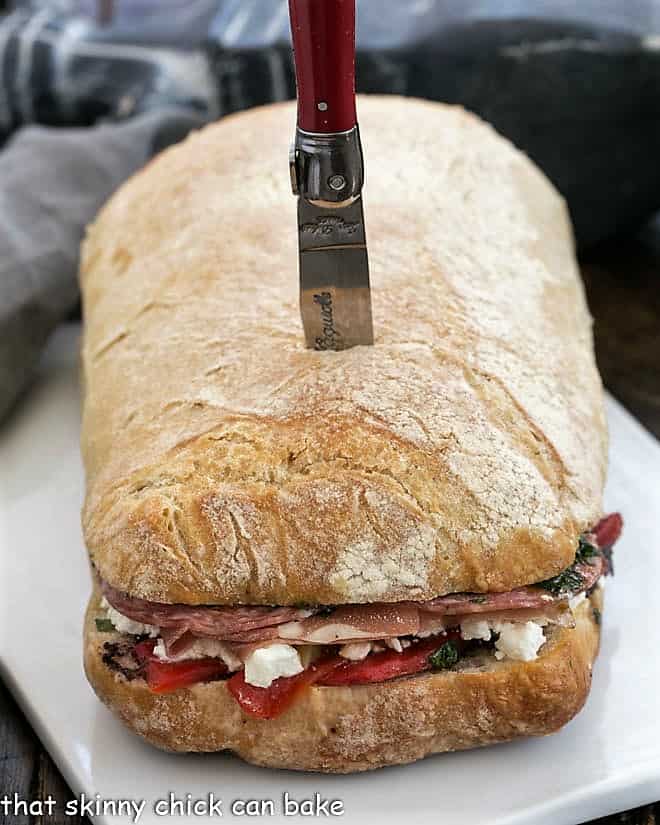 Picnic Sandwich before sliced on a ceramic tray