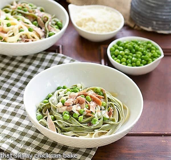 Straw and Hay Pasta in a white bowl on a green and white checkered napkin.