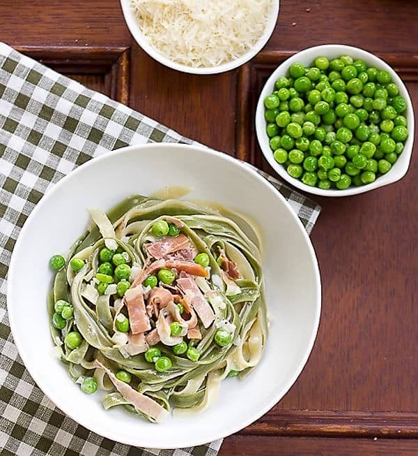  Overhead view of Straw and Hay Pasta in a white bowl.