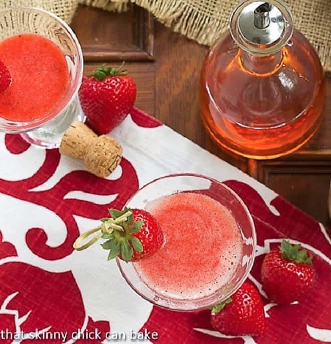 Overhead view of Strawberry Bellinis on a red and white napkin.