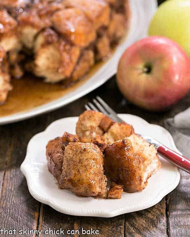 Apple Monkey Bread on a white ceramic plate with a red handled fork.