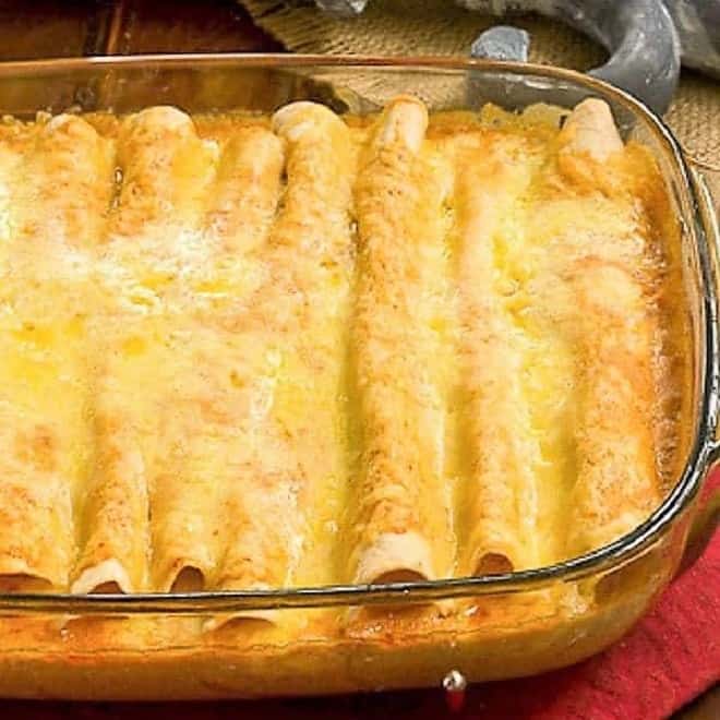 Cheesy Chicken Enchiladas in a Pyrex casserole dish