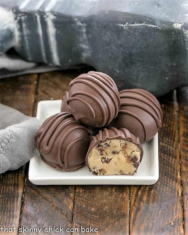 Stack of cookie dough truffles on a square white plate