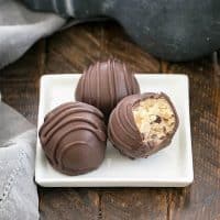 3 cookie dough bites on a square white plate