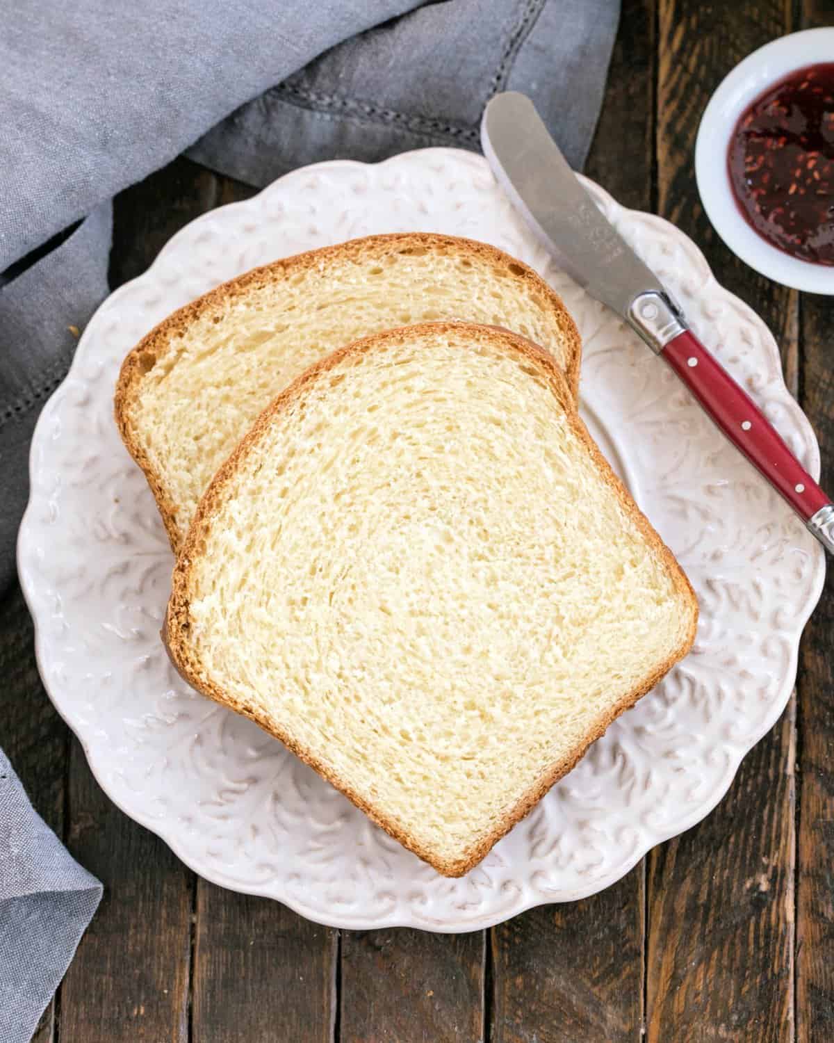 Overhead view of potato bread slices on a decorative white plate.
