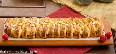 Horizontal view of Raspberry Danish Braid on a cutting board