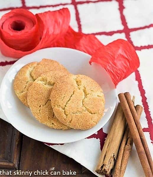 Brown Butter Snickerdoodles on a white plate with cinnamon sticks.