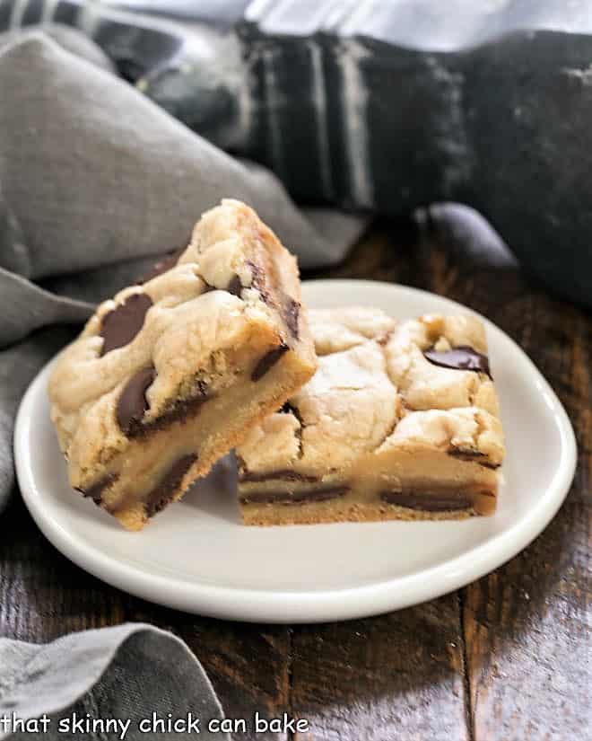 Two Caramel Chocolate Chip Cookie Bar on a small round white plate