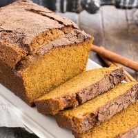 A partially sliced loaf of a pumpkin bread recipe